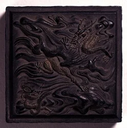 Ink-cake in seal form with a domed knop moulded in dramatic relief with two dragons among waves, attributed to Wang Wei-kao, Ching dynasty, Hui-chou, Anhui
